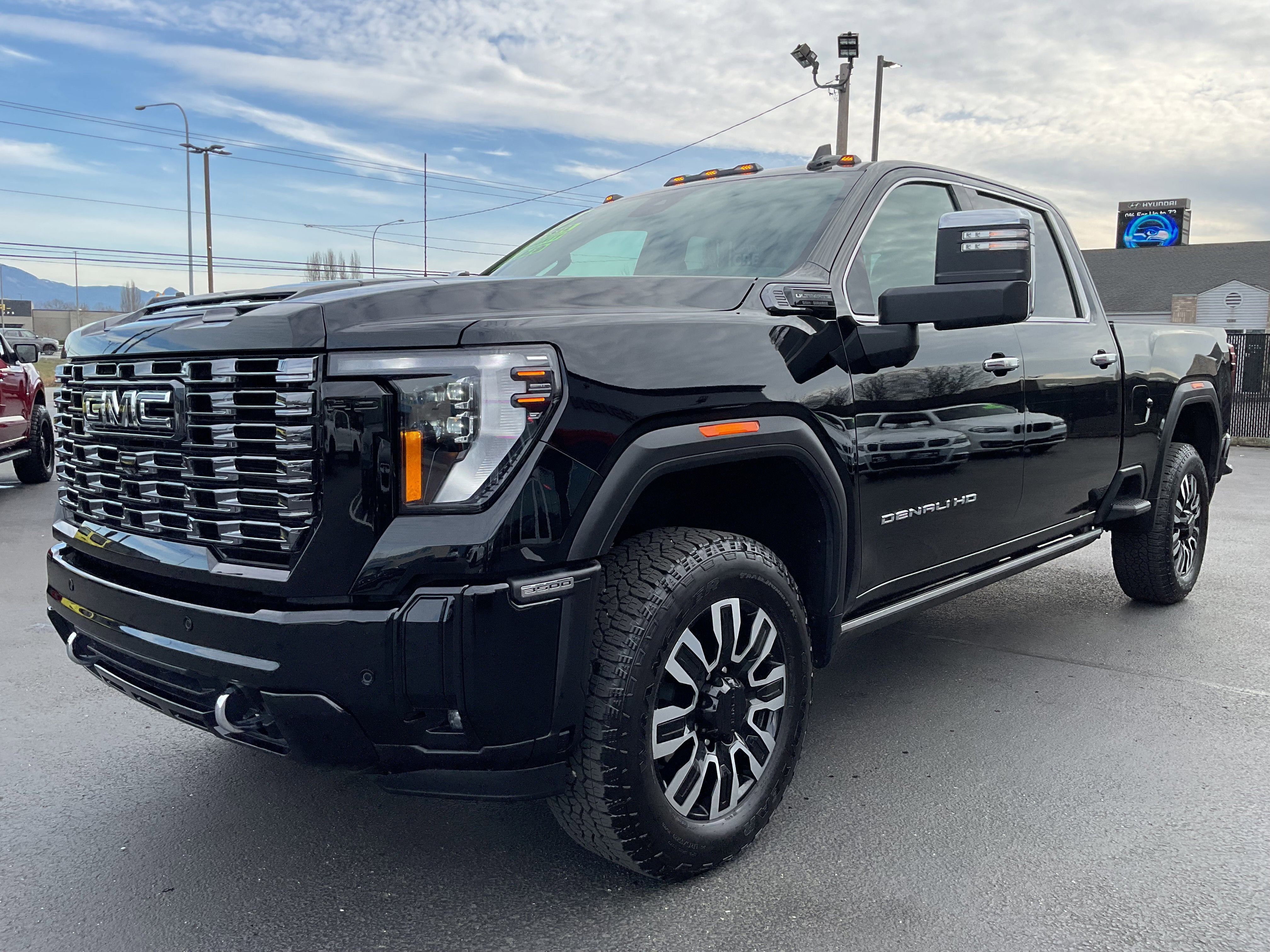 2025 GMC Sierra 3500HD Denali Ultimate Diesel 4x4 in Black — front three-quarter view